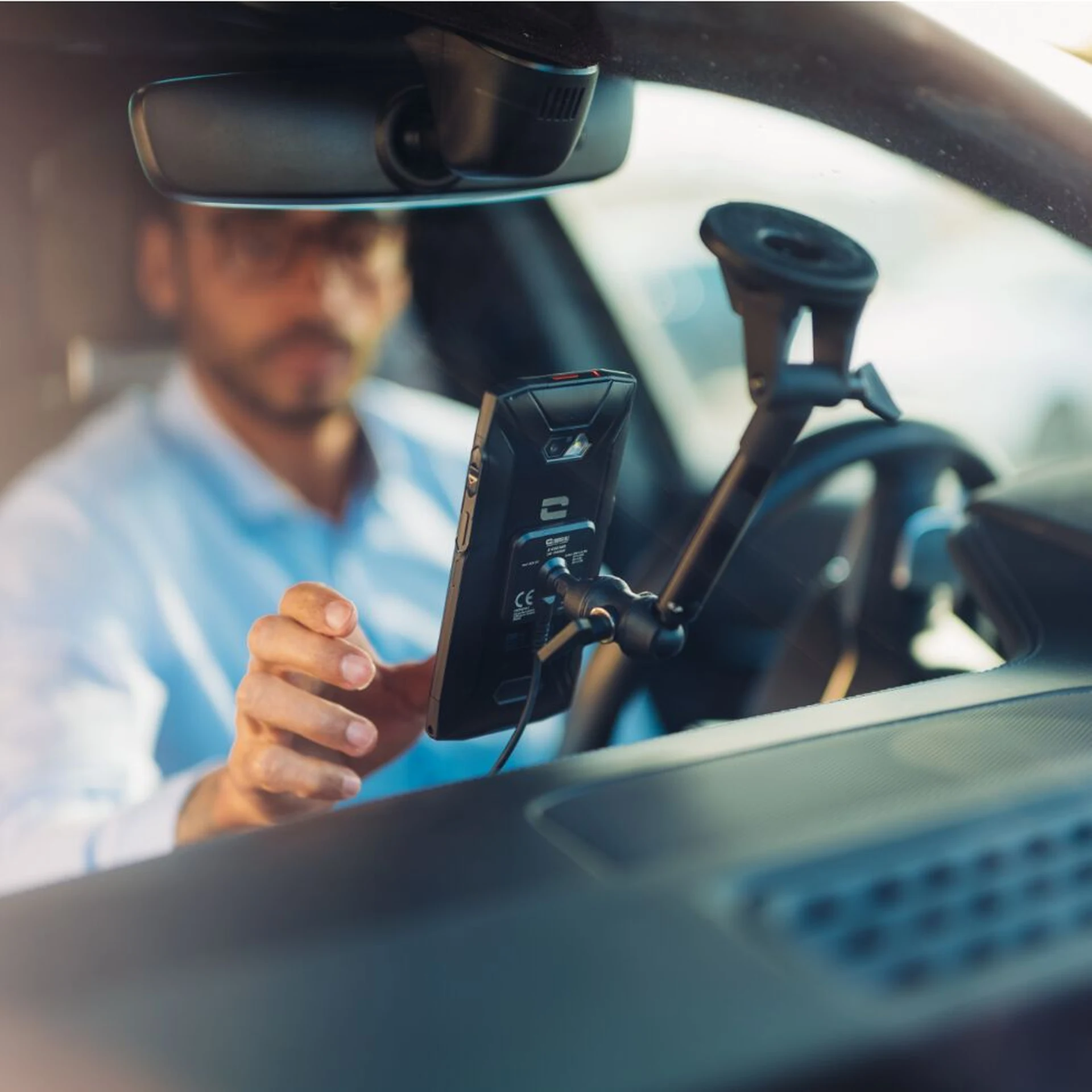 Crosscall X-Car Pro an der Windschutzscheibe eines Pkw mit aufgesetztem Smartphone